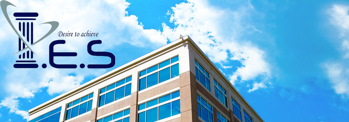 I.E.S logo with the words “Desire to achieve” above a modern office building against a blue sky