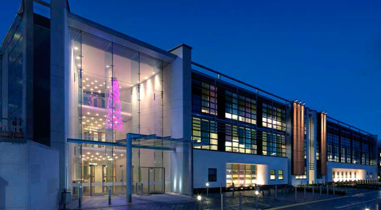 Glass-fronted building lit at dusk